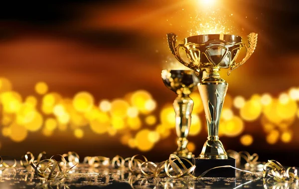 depositphotos_145442453-stock-photo-champion-golden-trophy-on-wood